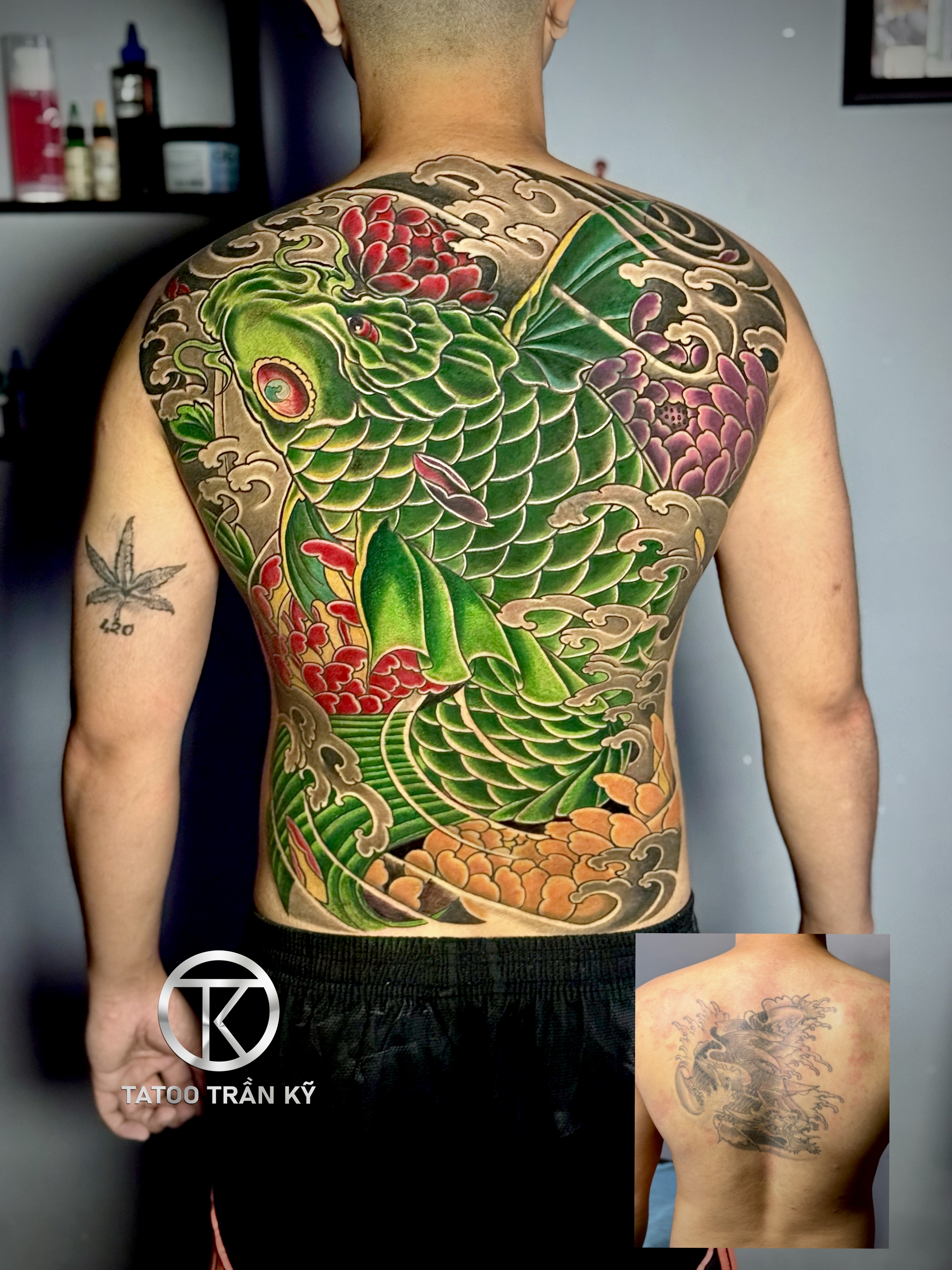 Full back carp tattoo overrides old tattoo