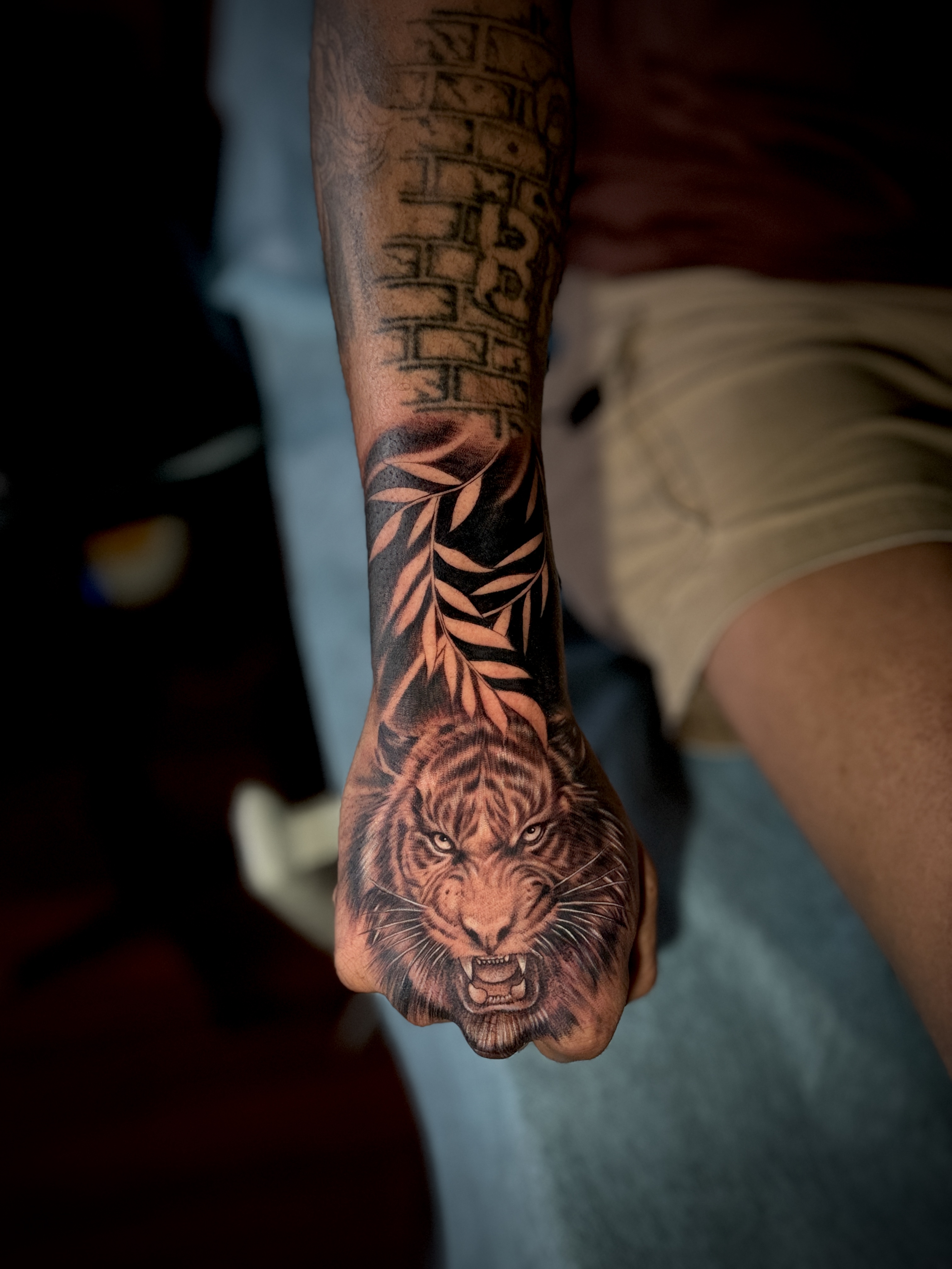 Tiger face tattoo on back of hand